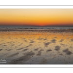 Reflets du soleil couchant sur le sable de la plage à Ault