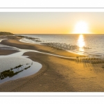 France, Pas-de-Calais (62), côte d'Opale, Grand site des deux caps, La plage de Tardinghen, ses bouchots pour la culture des moules, le cap Gris-nez en arrière plan au soleil couchant et l’épave du Lord Grey, ce chalutier britannique, long de 37 mètres, réquisitionné en 1915 par la Royal Navy et transformé en démineur, qui a sombré le 2 décembre 1917 lors d'une tempête  (Vue aérienne) // France, Pas-de-Calais (62), Opal Coast, Great site of the two capes, the beach of Tardinghen, its bouchots for the culture of mussels, the Cap Gris-nez in the background at sunset and the wreck of the Lord Grey, this British trawler, 37 meters long, requisitioned in 1915 by the Royal Navy and transformed into a mine-clearer, which sank on December 2, 1917 during a storm (aerial view)