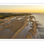 France, Pas-de-Calais (62), côte d'Opale, Grand site des deux caps, La plage de Tardinghen, ses bouchots pour la culture des moules, le cap Gris-nez en arrière plan au soleil couchant et l’épave du Lord Grey, ce chalutier britannique, long de 37 mètres, réquisitionné en 1915 par la Royal Navy et transformé en démineur, qui a sombré le 2 décembre 1917 lors d'une tempête  (Vue aérienne) // France, Pas-de-Calais (62), Opal Coast, Great site of the two capes, the beach of Tardinghen, its bouchots for the culture of mussels, the Cap Gris-nez in the background at sunset and the wreck of the Lord Grey, this British trawler, 37 meters long, requisitioned in 1915 by the Royal Navy and transformed into a mine-clearer, which sank on December 2, 1917 during a storm (aerial view)