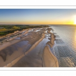 France, Pas-de-Calais (62), côte d'Opale, Grand site des deux caps, La plage de Tardinghen, ses bouchots pour la culture des moules, le cap Gris-nez en arrière plan au soleil couchant et l’épave du Lord Grey, ce chalutier britannique, long de 37 mètres, réquisitionné en 1915 par la Royal Navy et transformé en démineur, qui a sombré le 2 décembre 1917 lors d'une tempête  (Vue aérienne) // France, Pas-de-Calais (62), Opal Coast, Great site of the two capes, the beach of Tardinghen, its bouchots for the culture of mussels, the Cap Gris-nez in the background at sunset and the wreck of the Lord Grey, this British trawler, 37 meters long, requisitioned in 1915 by the Royal Navy and transformed into a mine-clearer, which sank on December 2, 1917 during a storm (aerial view)